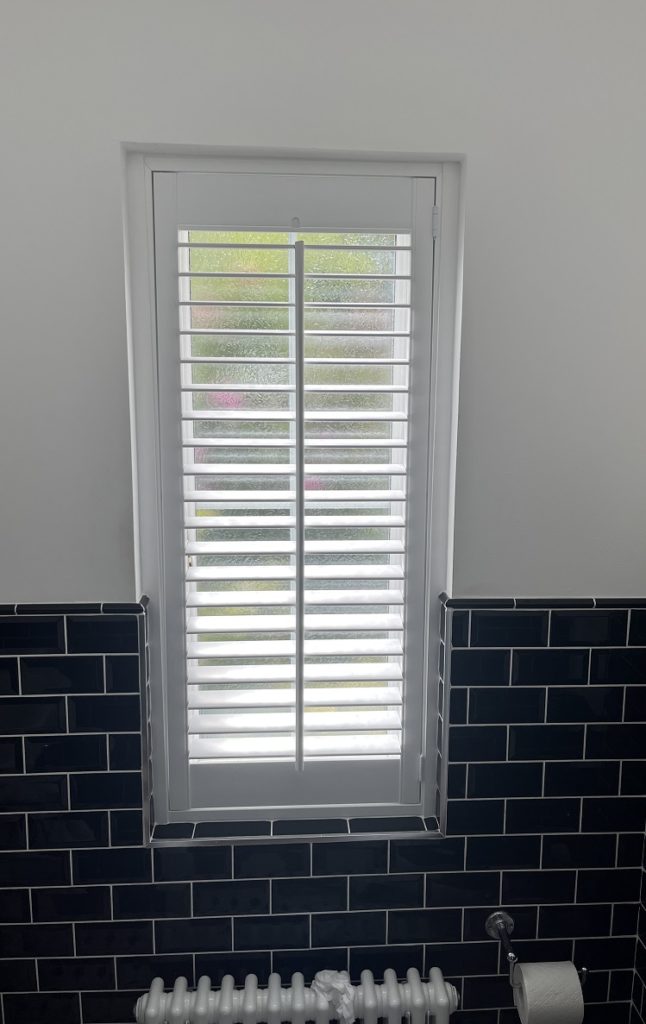Full height bathroom shutters with visible tilt