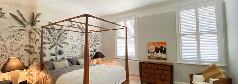 white wooden shutter blinds in tropical bedroom