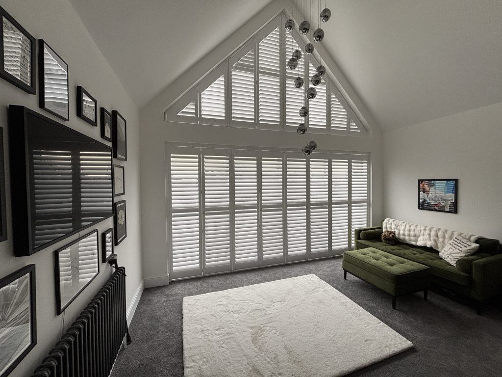 Special shape white shutters in a modern living room