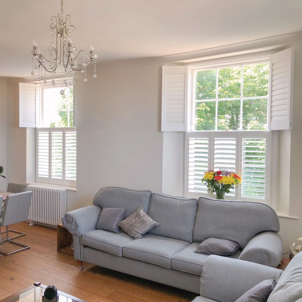 White tier-on-tier shutter blinds in living room