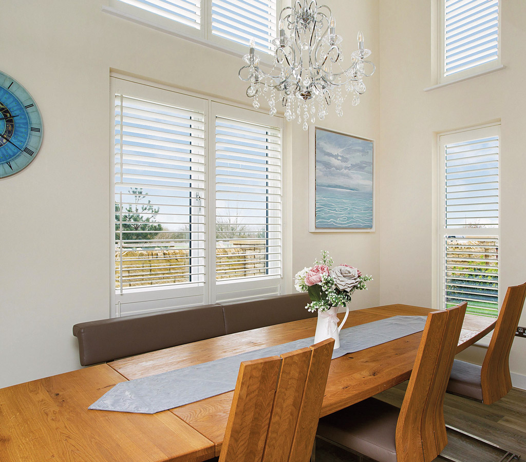 full height white shutters an alternative to blinds in dining room