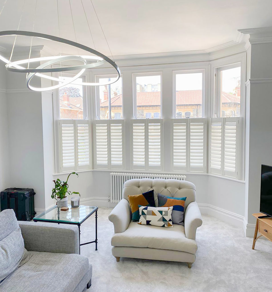 white cafe style shutters in living room