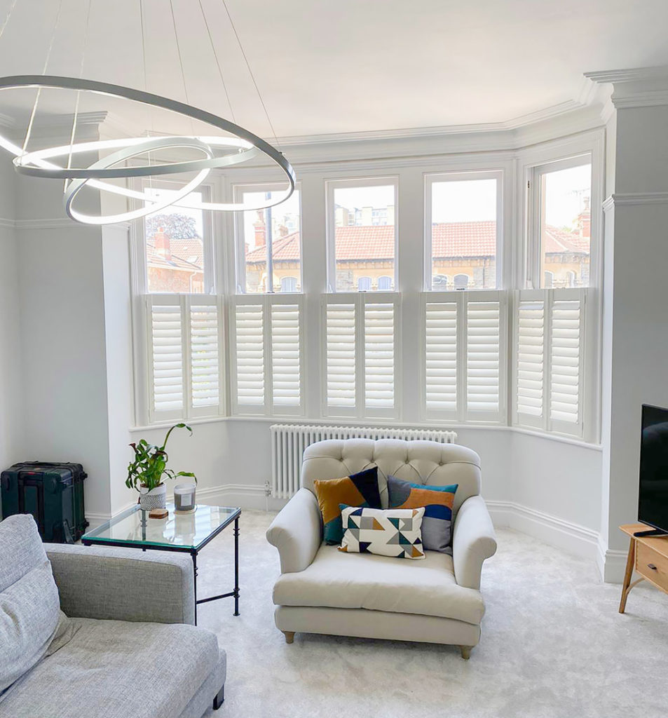 white cafe style shutters and alternative to blinds in living room