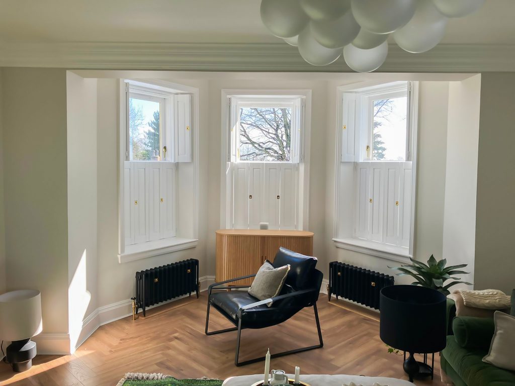 Solid panel tier-on-tier shutters for insulation in a modern contemporary living space